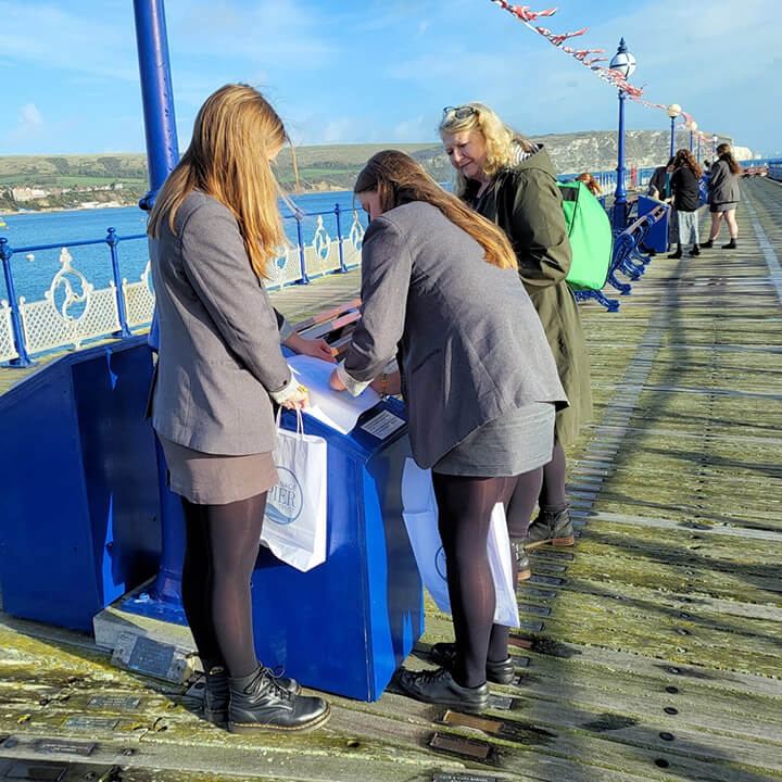 Swanage School students test out the stone rubbing trail on the pier